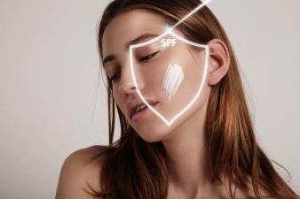 woman's face into a shield makes spf protection from ray